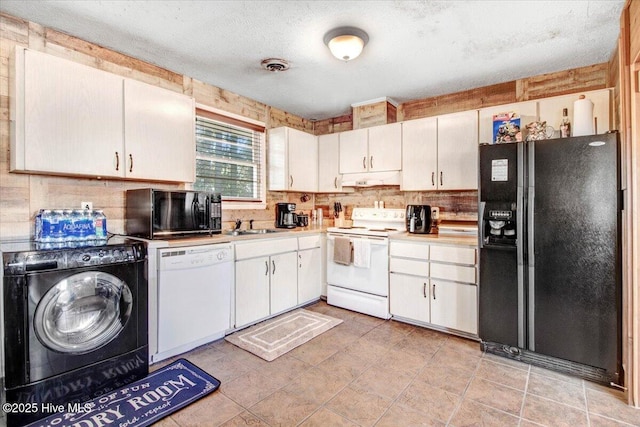 kitchen featuring visible vents, washer / dryer, black appliances, white cabinets, and light countertops