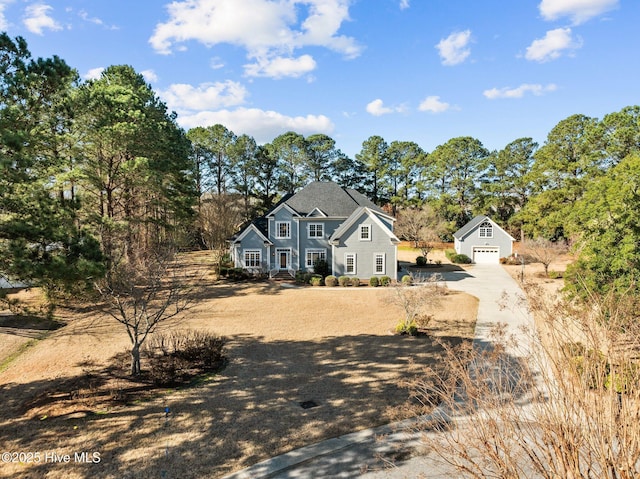 view of front of property with a detached garage and an outdoor structure