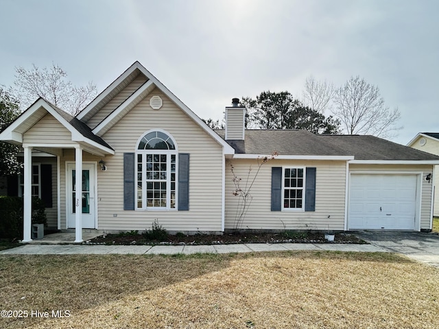 ranch-style home with a chimney, driveway, a front yard, and a garage