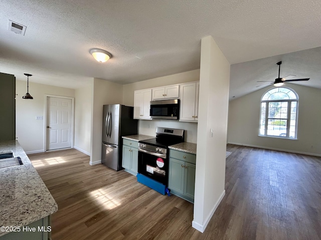 kitchen with dark wood-style floors, visible vents, a textured ceiling, and stainless steel appliances