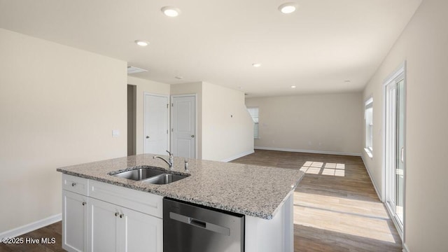 kitchen featuring a sink, wood finished floors, dishwasher, and a wealth of natural light