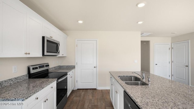 kitchen featuring white cabinetry, light stone countertops, recessed lighting, stainless steel appliances, and a sink