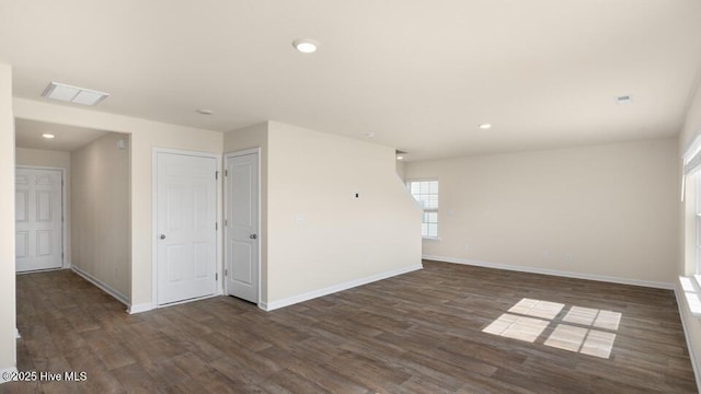 unfurnished room featuring recessed lighting, visible vents, baseboards, and wood finished floors