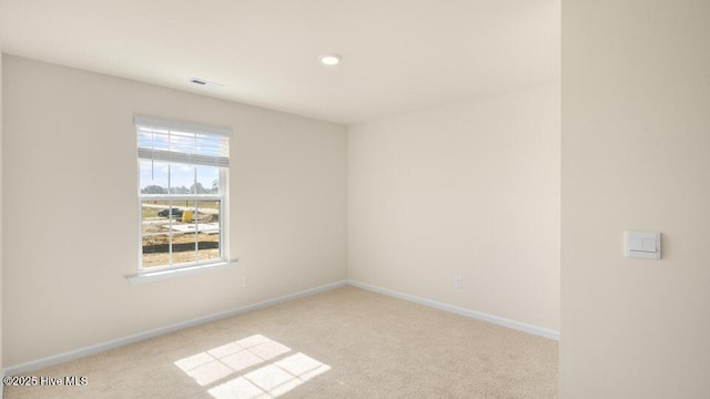 unfurnished room with baseboards and carpet floors