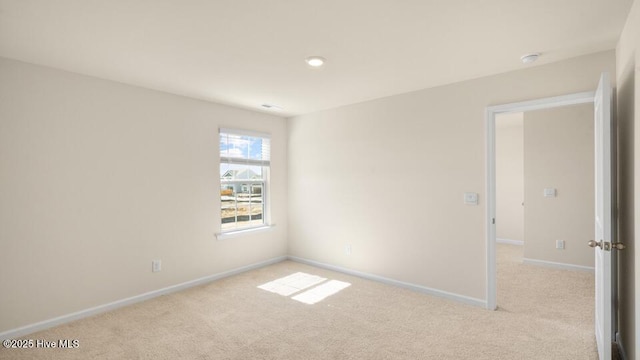 carpeted empty room with baseboards