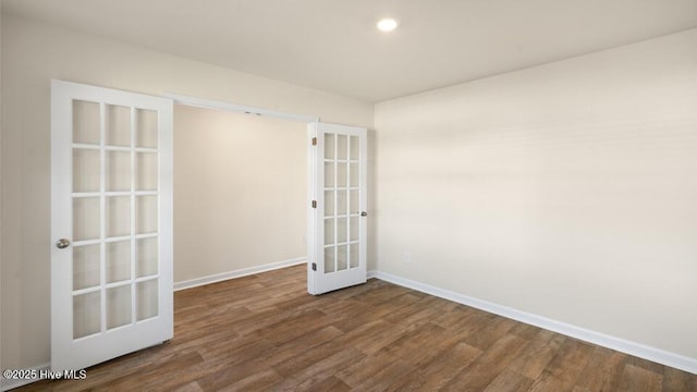 spare room with recessed lighting, french doors, baseboards, and dark wood-style flooring