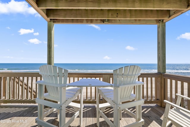 deck with a view of the beach and a water view