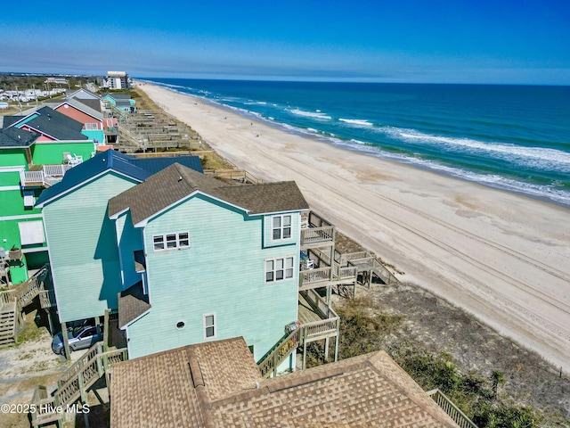 drone / aerial view featuring a water view and a view of the beach