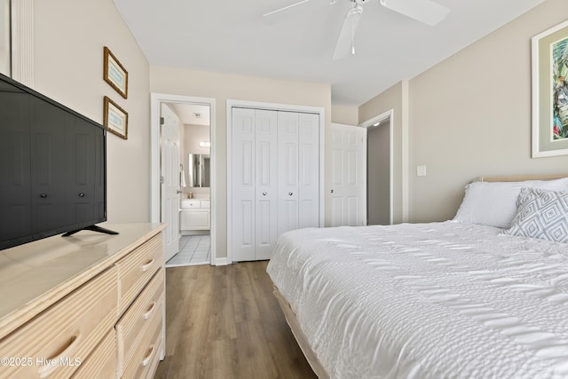 bedroom featuring ceiling fan, a closet, dark wood-type flooring, and connected bathroom