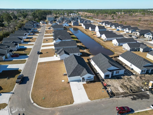 bird's eye view featuring a water view and a residential view