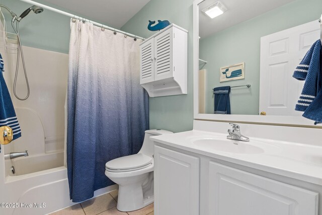 bathroom with tile patterned floors, shower / bath combo with shower curtain, toilet, and vanity