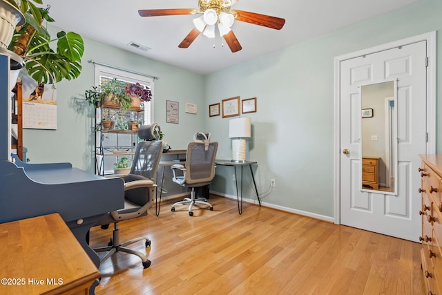 office area with a ceiling fan, baseboards, and light wood-style floors