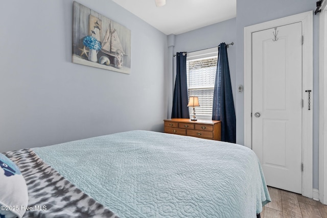 bedroom featuring wood finished floors and ceiling fan