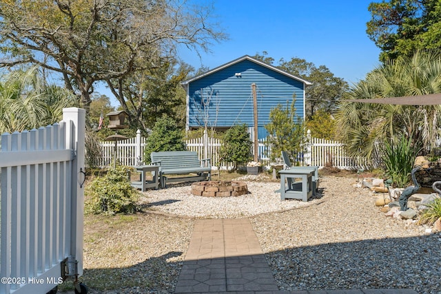 exterior space with fence and an outdoor fire pit