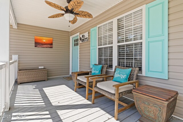 wooden terrace featuring covered porch and ceiling fan