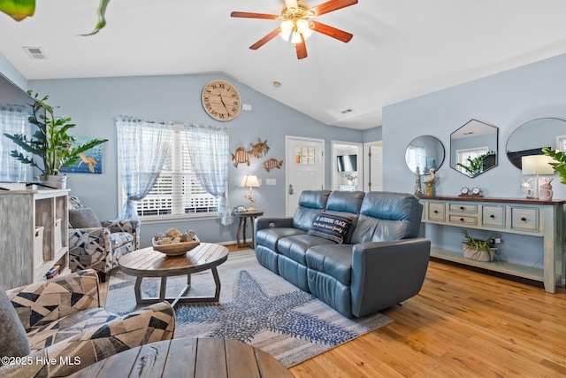 living area featuring a ceiling fan, wood finished floors, lofted ceiling, and visible vents