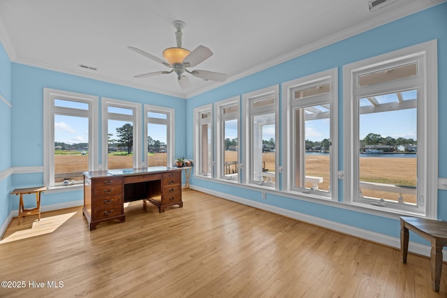 office area featuring visible vents, crown molding, baseboards, ceiling fan, and light wood-style flooring