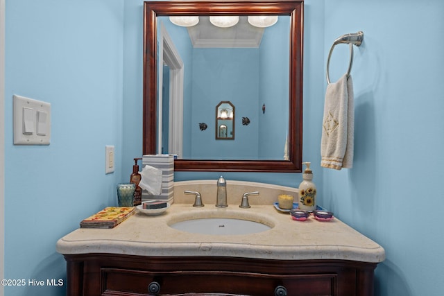 bathroom with ornamental molding and vanity