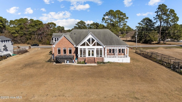 back of house with french doors, roof with shingles, and fence