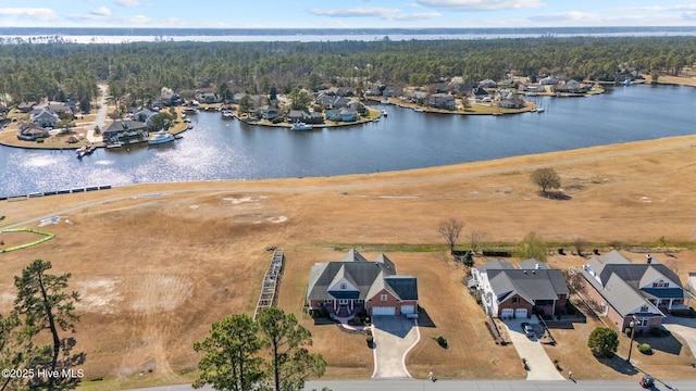 drone / aerial view featuring a water view and a wooded view