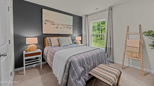 carpeted bedroom with visible vents and baseboards