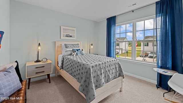 bedroom with carpet flooring, baseboards, and visible vents