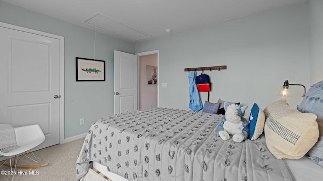 bedroom featuring baseboards, carpet, and attic access