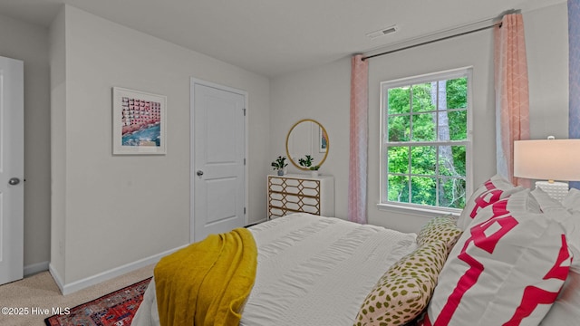 bedroom featuring visible vents, carpet, and baseboards