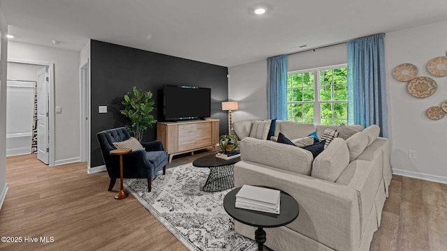 living area with recessed lighting, baseboards, and wood finished floors