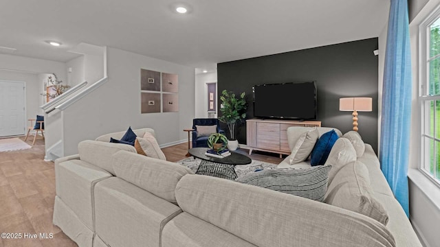 living room featuring recessed lighting, stairs, baseboards, and wood finished floors