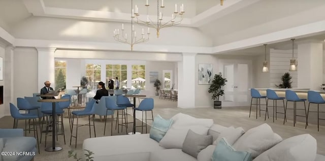 living area featuring an inviting chandelier, a high ceiling, and a tray ceiling