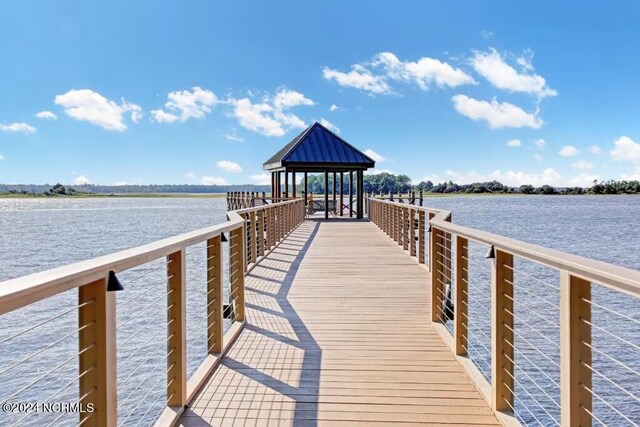 view of dock with a gazebo and a water view