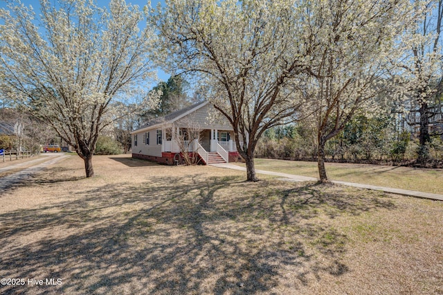 view of front of property with crawl space and a front yard