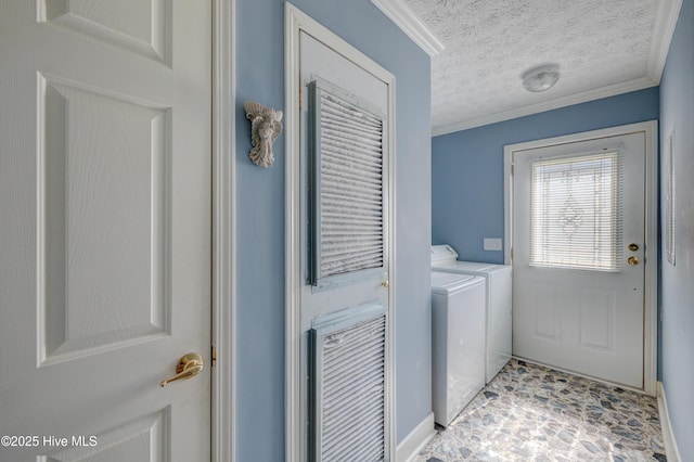 laundry room with washer and clothes dryer, laundry area, a textured ceiling, and crown molding