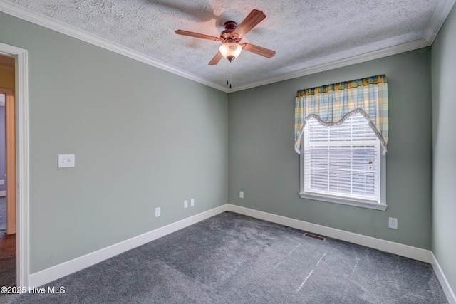 spare room with visible vents, baseboards, ceiling fan, carpet floors, and ornamental molding