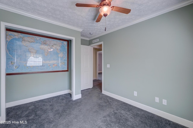 unfurnished bedroom featuring ceiling fan, baseboards, ornamental molding, carpet floors, and a textured ceiling