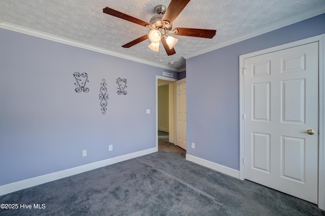 unfurnished bedroom featuring baseboards, carpet floors, ceiling fan, ornamental molding, and a textured ceiling