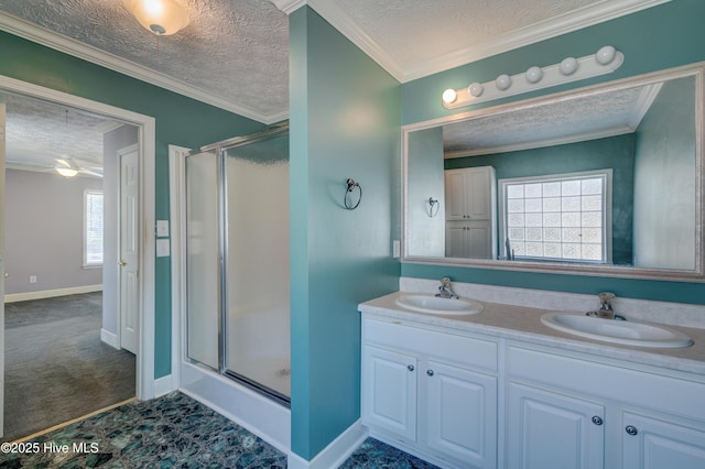 full bath with a stall shower, a textured ceiling, and a sink