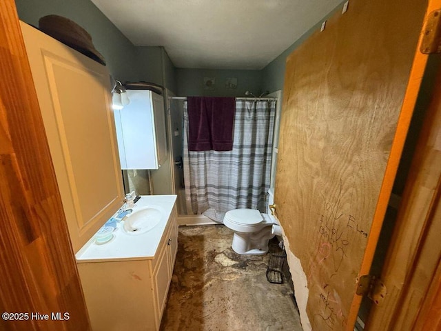 bathroom with toilet, unfinished concrete floors, a stall shower, and vanity