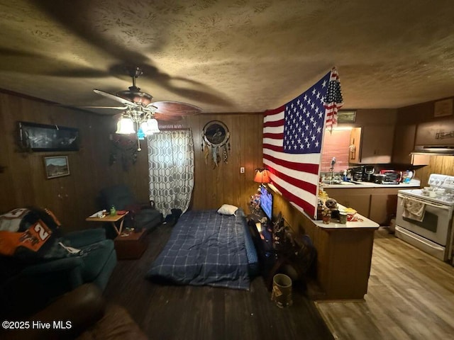 bedroom featuring wood finished floors and wood walls