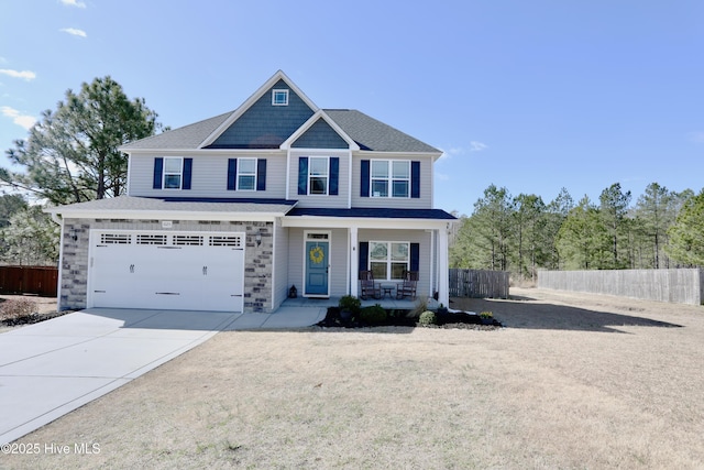 view of front of property with a porch, concrete driveway, an attached garage, and fence