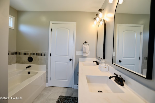 bathroom with tile patterned flooring, double vanity, a bath, and a sink