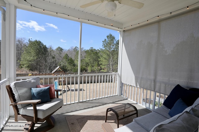 sunroom / solarium featuring ceiling fan