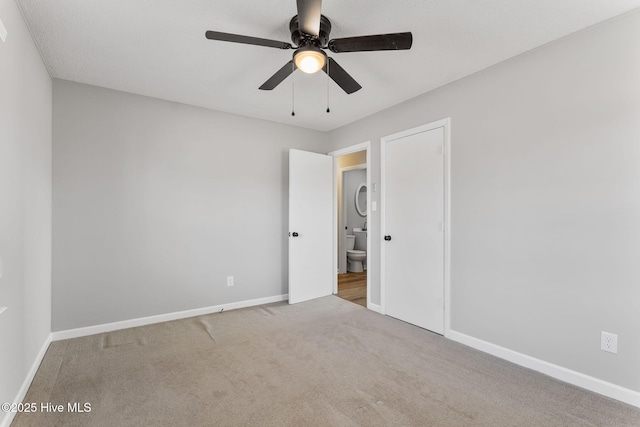 carpeted empty room with baseboards and ceiling fan