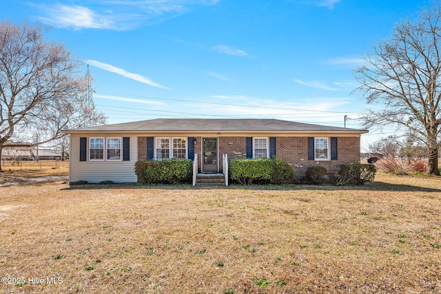 single story home featuring brick siding and a front yard