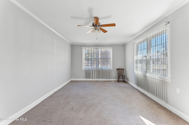 unfurnished room with a textured ceiling, baseboards, and ornamental molding