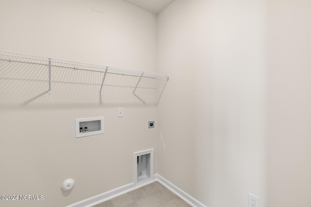 laundry area with baseboards, gas dryer hookup, washer hookup, laundry area, and hookup for an electric dryer