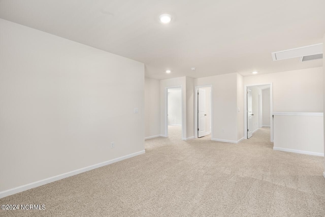 empty room with visible vents, recessed lighting, light colored carpet, and baseboards