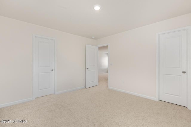 unfurnished bedroom featuring carpet flooring and baseboards