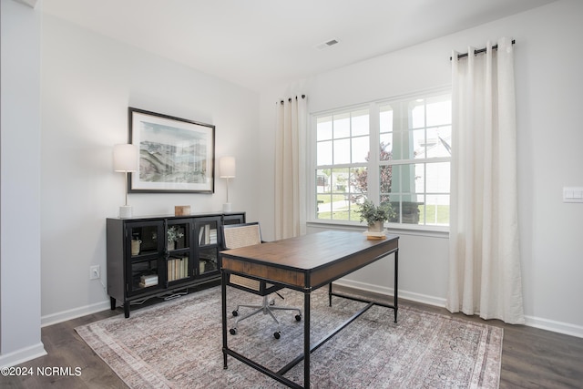 home office featuring wood finished floors, visible vents, and baseboards